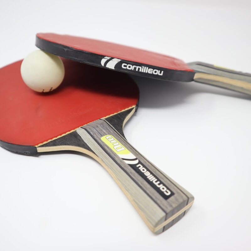 two red pingpong rackets on white surface
