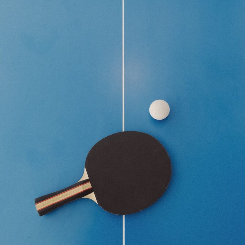 a ping pong paddle and a ping pong ball